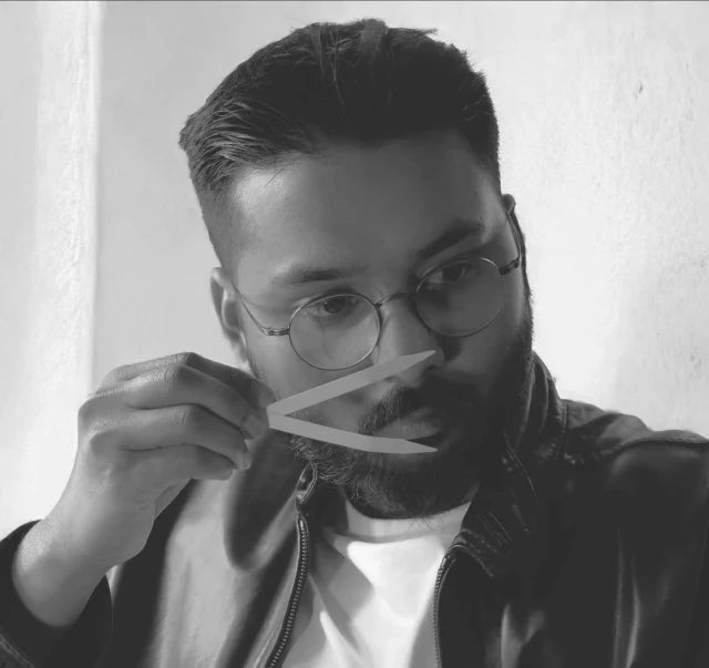 Man testing fragrances with scent strips, black and white, artisan perfumery