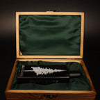Pineward 100ml bottle lying in the open wooden coffret on green satin